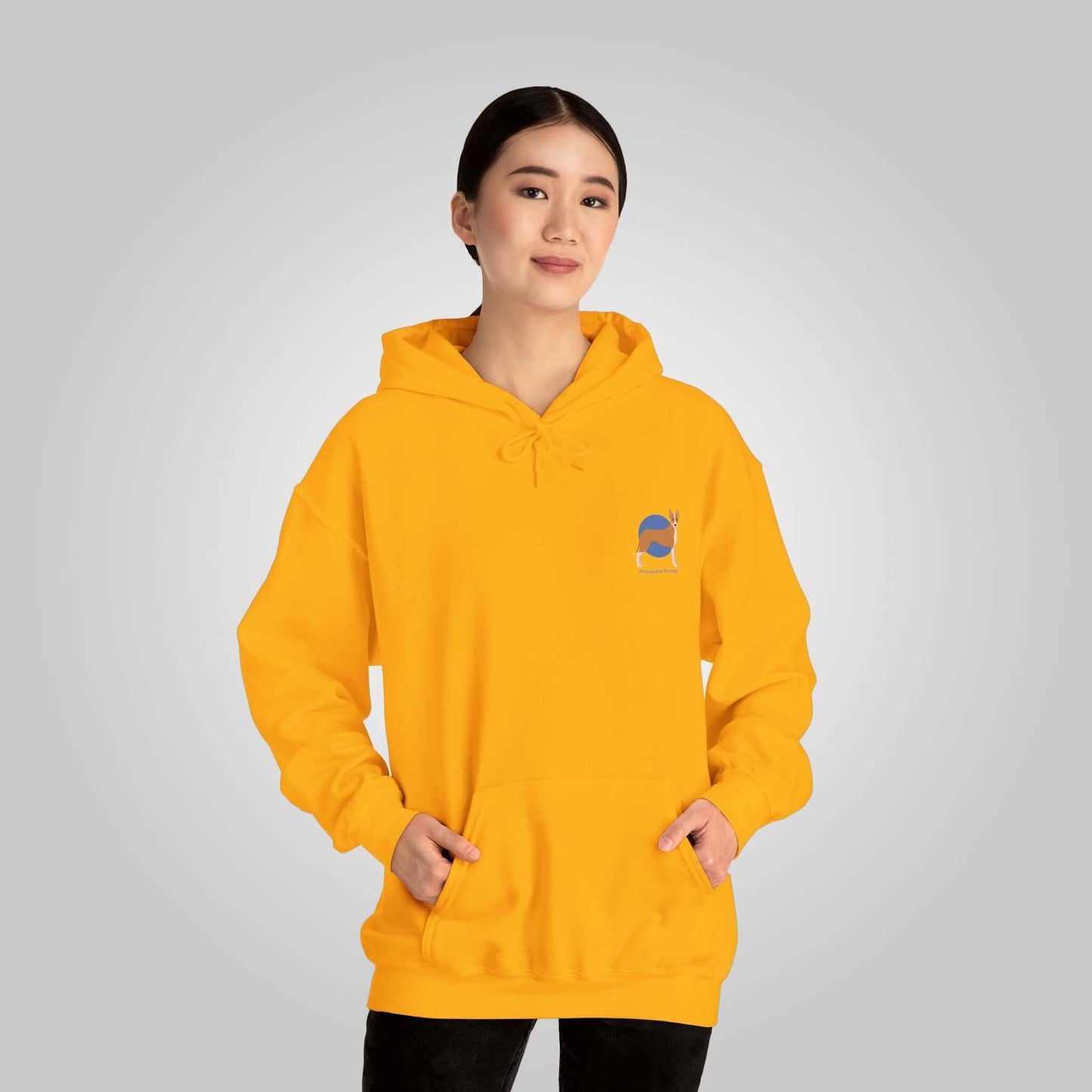 Woman wearing a bright yellow Portuguese Podengo unisex hoodie with front pocket and dog design-badge.