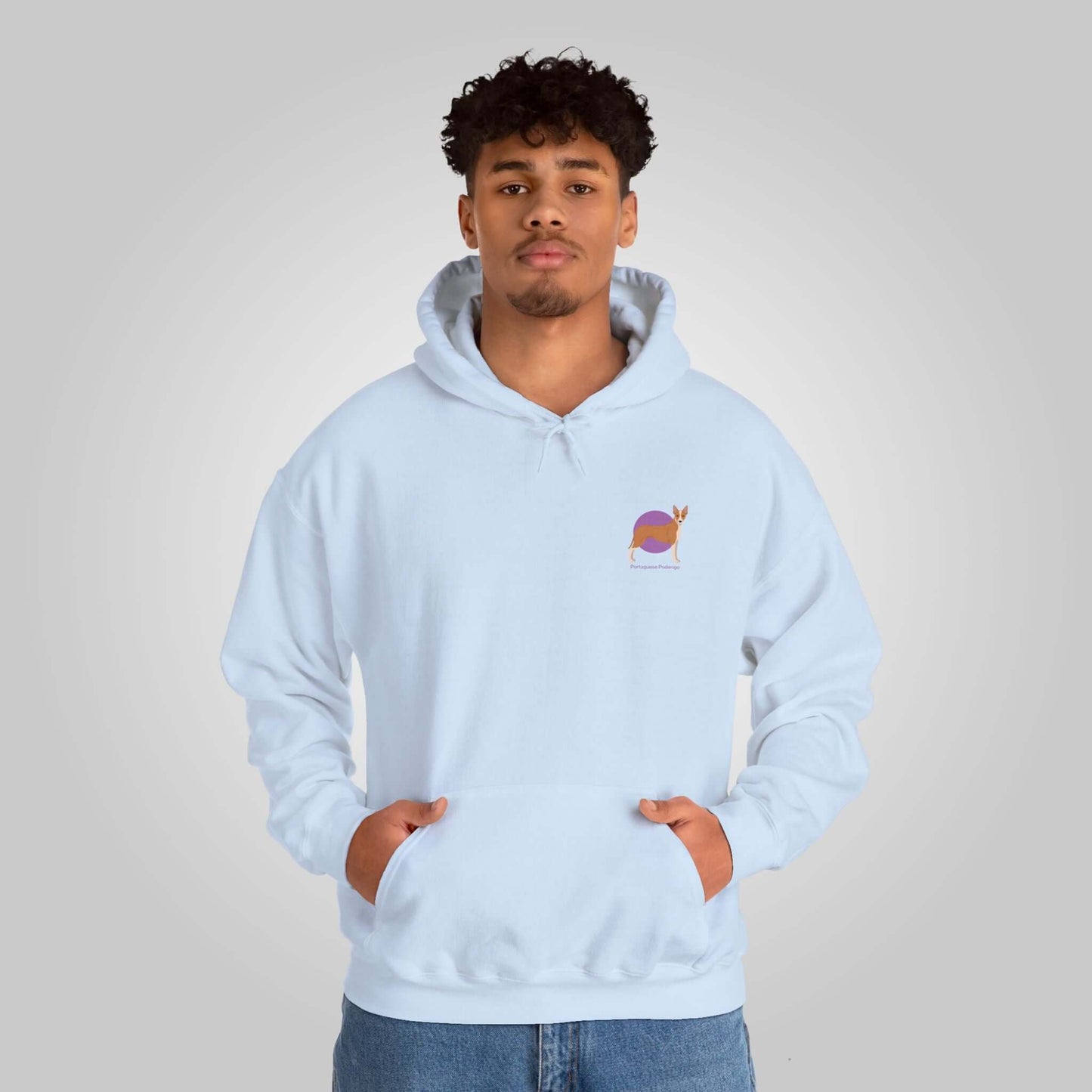 Man wearing a light blue Portuguese Podengo dog hoodie, hands in pockets, casual style