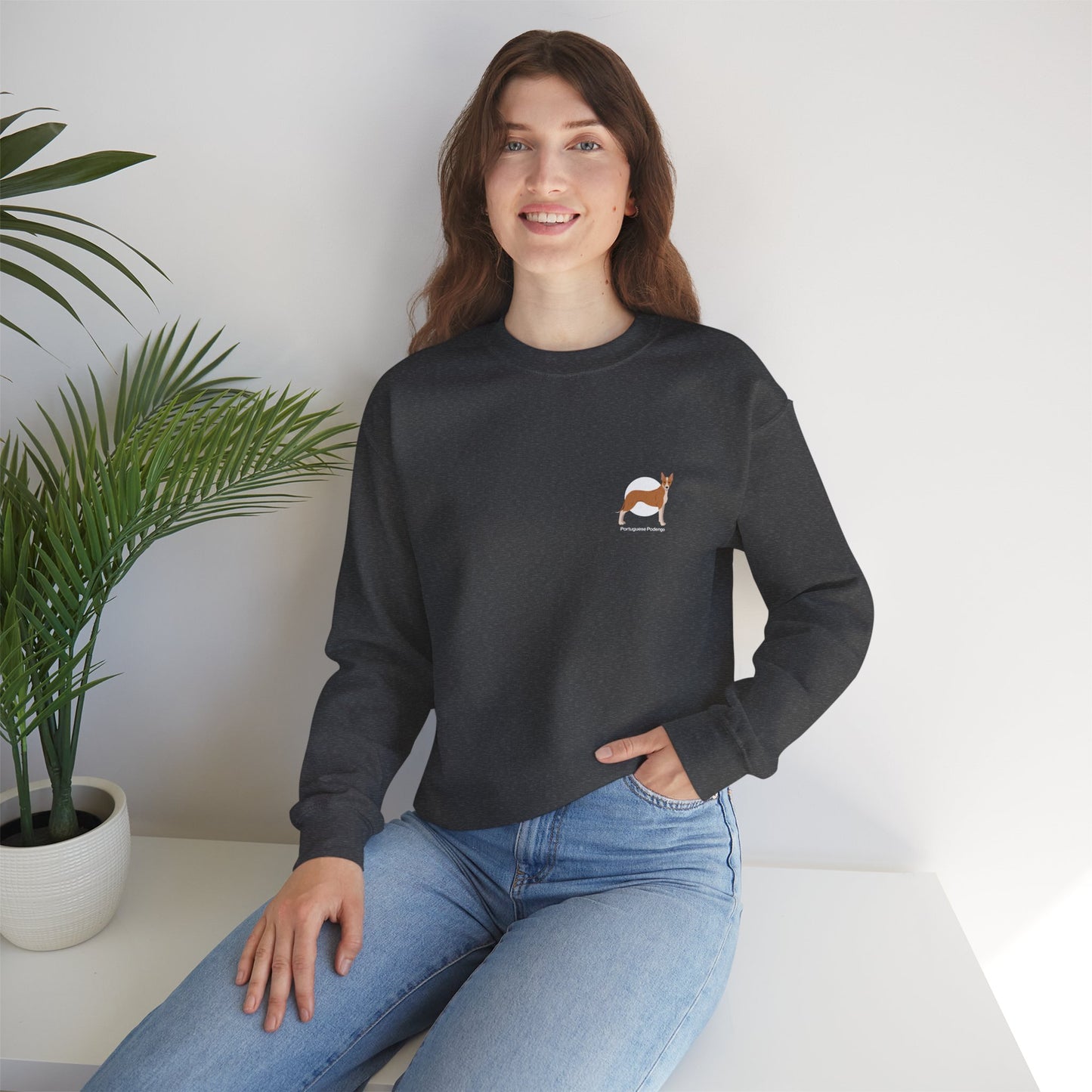 Woman wearing a Portuguese Podengo dog unisex heavy blend crewneck sweatshirt in a casual setting